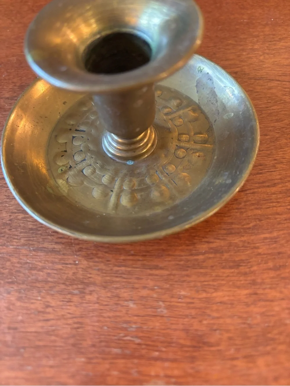 vintage brass chamberstick candle holder with a circular base and a ring handle